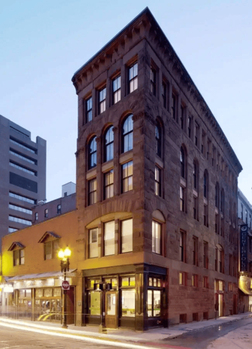 Four-story brick building on the corner of a street